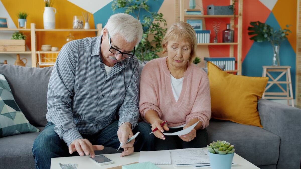 Older couple reviewing paperwork together at a table